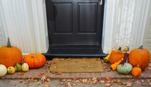 October property market. Pumpkins on the front steps of a home.