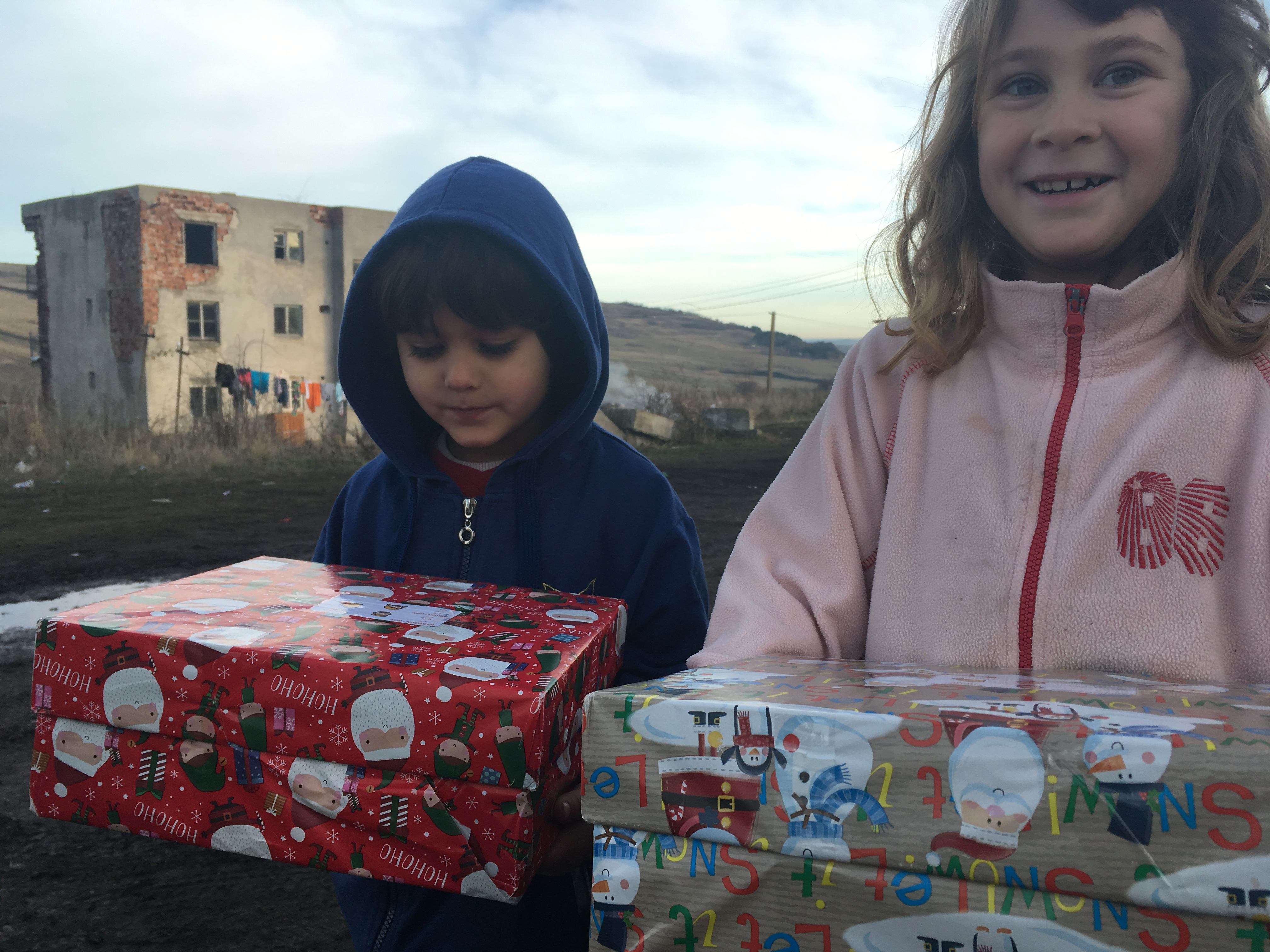 Agency Express Christmas shoebox appeal - Young gir and boy with gift