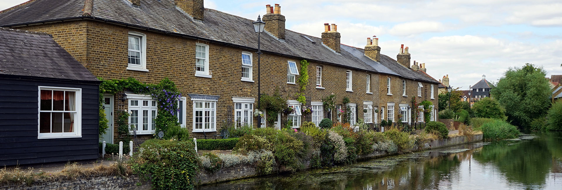 Row of cottages next to a river - Property Activity Reports